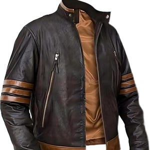 May include: A dark brown leather jacket featuring a stand-up collar with a snap button closure, a tan interior lining, and two vertical zippered chest pockets. The sleeves are accented with two horizontal brown stripes, and the hem is tan.