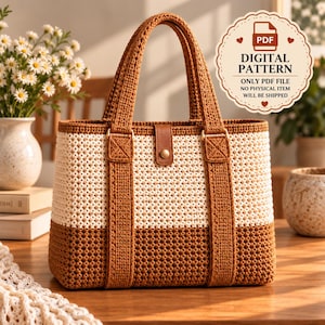 May include: A two-toned crochet tote bag featuring a cream-colored upper section and a brown lower section with brown handles. A brown leather-like tab with a gold-colored snap button secures the center. Text reads: PDF DIGITAL PATTERN.