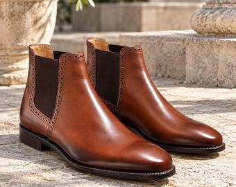 Donkerbruine leren Chelsea boots voor heren, enkellaarsjes met brogue-afwerking.