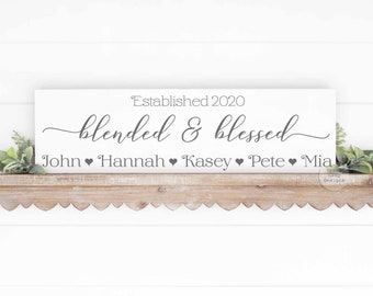 May include: White wooden sign with the text "Established 2020 blended & blessed" and the names "John, Hannah, Kasey, Pete, Mia" separated by hearts.