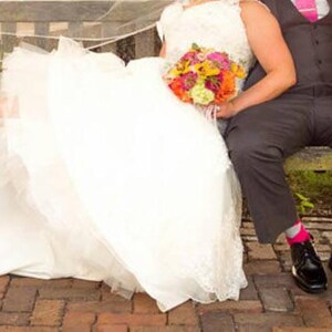 Bride and groom photo, bride wearing magenta lace wedding heels.