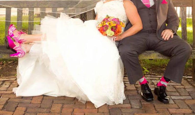 Bride and groom photo, bride wearing magenta lace wedding heels.