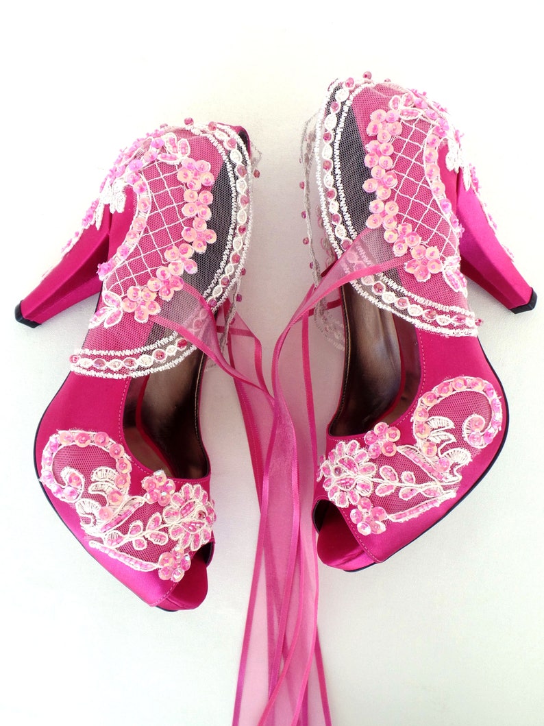 Magenta bridal shoes with floral embellished lace appliques and organza ties. Romantic wedding shoes color pop.