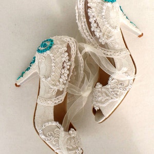 Floral lace bridal shoes with teal beadwork on the heels. Elegant wedding shoes for teal weddings.