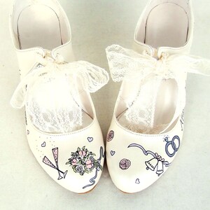 Custom wedding shoes with lace ties, handpainted wedding rings, bridal bouquet, champagne glasses, church bells and little hearts.