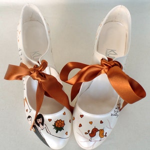 personalized bridal shoes with burnt orange ribbons, love birds, bride and groom and flower painting on the front.