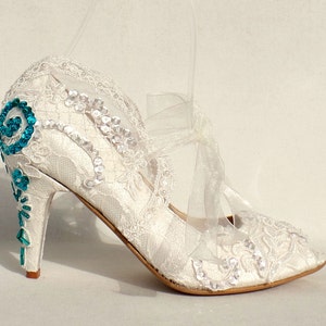 Floral lace beaded bridal shoe with teal accent color on the heels.