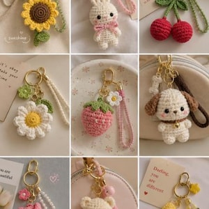 May include: A collection of nine handmade crochet keychains featuring various designs including a sunflower, a white rabbit, red cherries, a daisy, a strawberry, a puppy, a pink tulip, a teddy bear, and a yellow star, all with gold-tone hardware.