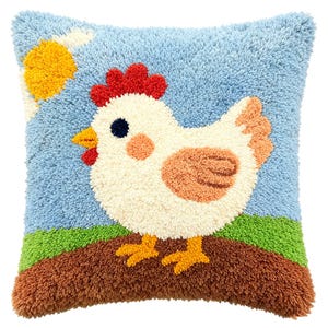 May include: A square throw pillow featuring a textured punch needle design of a white chicken with a red comb and wattle, standing on brown soil against a light blue sky with a yellow sun. The chicken has orange wings and yellow feet.