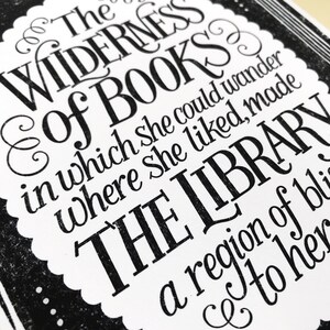 May include: Black and white typography print with the text "The Wilderness of Books in which she could wander where she liked, made The Library a region of bliss to her."