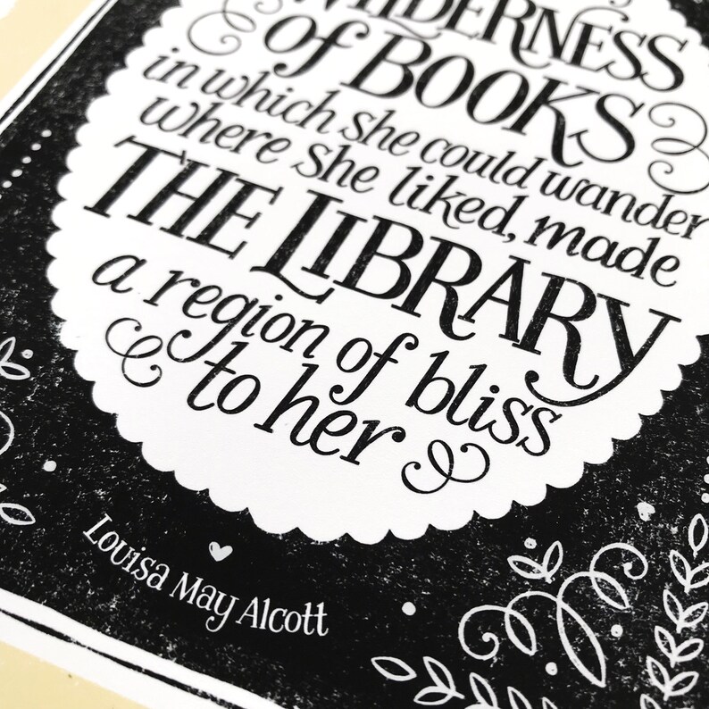 May include: Black and white typography print with a quote about books and libraries by Louisa May Alcott. The quote reads "& of BOOKS? in which she could wander where she liked, made THE LIBRARY a region of bliss to her."