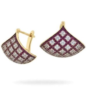May include: A pair of gold earrings featuring a fan-shaped design. The surface of each earring is covered in a grid pattern of small, round, clear white stones alternating with clusters of small, round, deep pink-red stones.