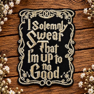 May include: A black rectangular embroidered patch with a decorative gold border. The text reads, "I Solemnly Swear That I'm up to no Good." The design includes a small letter H at the top and a pair of circular glasses at the bottom in gold thread.