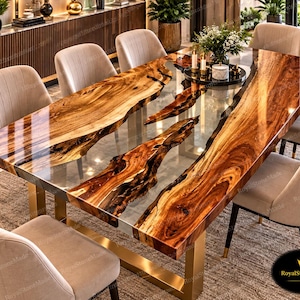 May include: A rectangular dining table featuring a live edge wood slab with a high-gloss finish and a clear resin center inlay. The table is supported by gold-toned metal legs and is surrounded by eight upholstered chairs with light beige fabric.