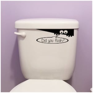 May include: White toilet with a black and white decal of a monster peeking over the top with the text "Did you flush?"