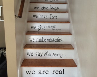 May include: White painted wooden staircase with black lettering on each step. The text reads: "We are family, We love, We do really loud, We forgive, We give hugs, We have fun, We give second chances, We make mistakes, We say I'm sorry, We are real, In this house."