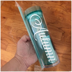 May include: A clear turquoise tumbler with a white vinyl decal that says "Mommy". The tumbler comes with a clear plastic straw.