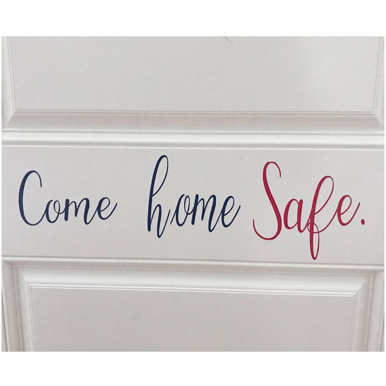 May include: A white door with a navy blue and red vinyl decal that reads "Come home Safe."