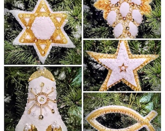 May include: A collage of handmade Christmas ornaments in various shapes, including stars, a bell, and a fish. The ornaments are white and gold, with glitter and bead embellishments. They are hanging on a green Christmas tree.