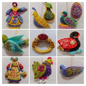 May include: A collection of handmade felt ornaments, including a doll, birds, a ring, a swan, and a rooster. The ornaments feature vibrant colors like yellow, blue, red, and green, with intricate beadwork and embroidery details. Each ornament has a gold string for hanging.