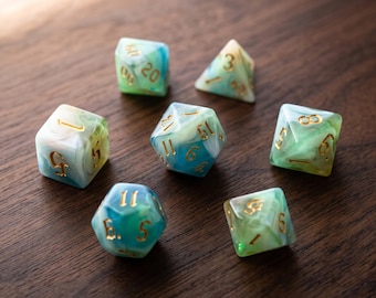 May include: A set of seven polyhedral dice featuring a marbled blend of teal, light blue, and white colors. Each die has engraved numbers filled with gold-colored ink, including a twenty-sided die, a twelve-sided die, and various other shapes.
