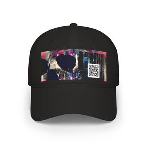 May include: A black baseball cap featuring a rectangular graphic print on the front panel. The design displays abstract dark shapes, vertical lines, and a white square containing a black QR code set against a vibrant, multi-coloured background.