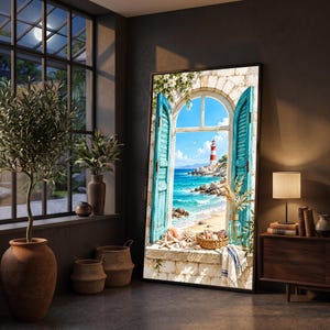May include: A large rectangular wall art print featuring an arched window with open bright blue shutters looking out onto a coastal scene with a red and white lighthouse, turquoise ocean, sandy beach, and a collection of seashells on the sill.