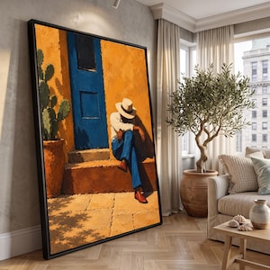 Puede incluir: Una impresión de arte mural enmarcada que representa a una persona con camisa blanca, pantalones azules y sombrero, sentada en unos escalones junto a una puerta azul brillante y un cactus en maceta contra una pared naranja texturizada.