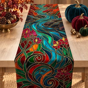 May include: A rectangular table runner featuring a vibrant stained glass pattern with flowing blue water motifs, swirling green foliage, and bright red floral accents outlined in gold, creating a colorful decorative surface covering.