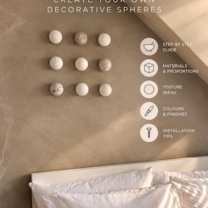 May include: A DIY wall decor guide for creating decorative spheres, featuring text that reads DIY WALL DECOR CREATE YOUR OWN DECORATIVE SPHERES. Nine spheres are arranged in a grid on a beige wall above a bed with white pillows.