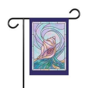 May include: A rectangular garden flag featuring a stained glass style illustration of a seashell. The design displays a central pink and tan seashell surrounded by swirling blue, purple, and teal watercolor patterns, all framed by a dark blue border.