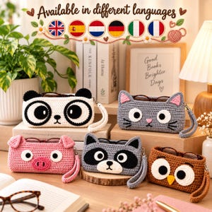 May include: Five rectangular crochet cases designed as animal faces: a white and black panda, a gray cat with pink ears, a pink pig, a gray and black raccoon, and a brown owl. Each case features a wrist strap and holds a pair of eyeglasses.