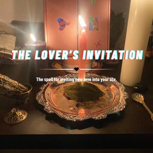May include: A silver-toned decorative tray holds a pink candle, a green leaf with text, and granular material. The text reads THE LOVER'S INVITATION and The spell for inviting new love into your life. A black candle, a sage bundle, and a gold spoon are nearby.