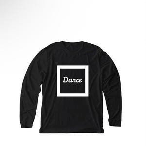 May include: A black long-sleeve shirt featuring a white square frame on the chest. Inside the square, the word "Dance" is printed in a white, cursive script font. The garment has a crew neckline and long sleeves with ribbed cuffs.