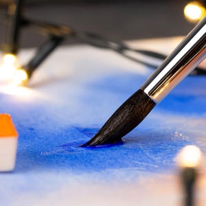 May include: A set of three ceramic mugs with a speckled, matte finish. The mugs are in shades of cream, light gray, and dark gray. Each mug has a simple, minimalist design, perfect for coffee or tea.