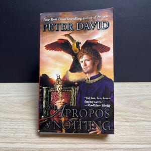May include: A paperback book titled Sir Apropos of Nothing by Peter David. The cover features a person in a purple tunic holding a golden staff, with a large bird flying in a sunset sky. Text includes New York Times bestselling author of Imzadi.