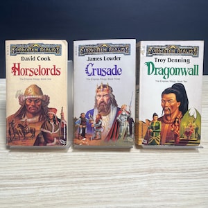 May include: Three Forgotten Realms fantasy adventure paperbacks from The Empires Trilogy. The books are titled Horselords by David Cook, Crusade by James Lowder, and Dragonwall by Troy Denning, each featuring detailed character illustrations on the cover.