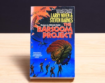 May include: A mass market paperback book titled The Barsoom Project by Larry Niven and Steven Barnes. The cover features a large, segmented, multi-colored creature, a group of figures holding glowing weapons, and a dark blue background.