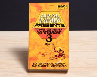 May include: A paperback book titled Isaac Asimov Presents The Great SF Stories 3 (1941) edited by Isaac Asimov and Martin H. Greenberg. The cover is orange with a yellow hexagon containing black text and an illustration of a figure in a suit.