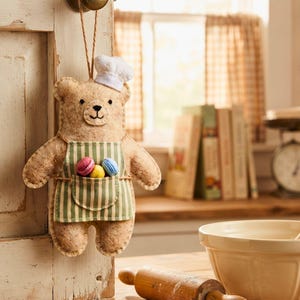 Hand sewn Baker Bear ornament with chef toque, striped apron and embroidered face