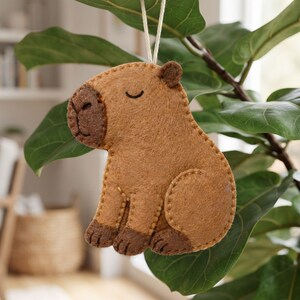 Capybara felt sewing pattern pieces including the body, snout, ear, front paws and back paw with printed measurements.