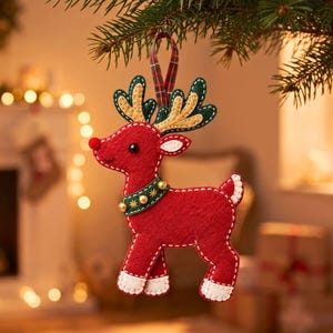 Felt reindeer Christmas ornament with green antlers and jingle bell harness hanging on pine tree branch