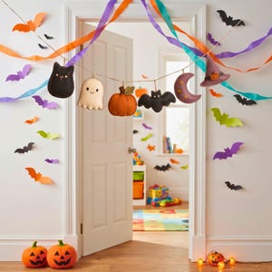 Felt Halloween garland strung as a banner above a Halloween party dessert table