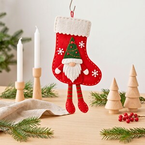Christmas gnome stocking sewing pattern pieces including stocking body, cuff, hat, beard, nose, coat, arms, legs, shoes and snowflakes.