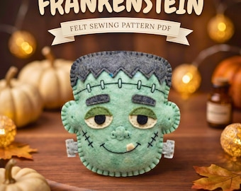May include: A light green felt Frankenstein monster head with dark gray hair, black stitched eyebrows, a single white tooth, and gray bolts on the sides. The text FRANKENSTEIN FELT SEWING PATTERN PDF is displayed above the felt craft item.