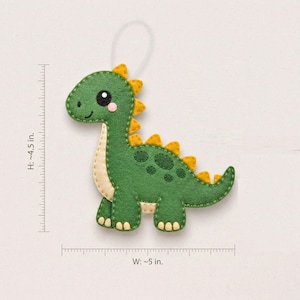 Kawaii dinosaur felt ornament pattern showing approximately 4.5 inch height, 5 inch width, 1-inch scale reference and measured template pieces.