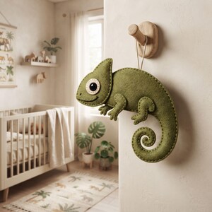 Hand sewn felt chameleon ornament showing four legs and detailed face