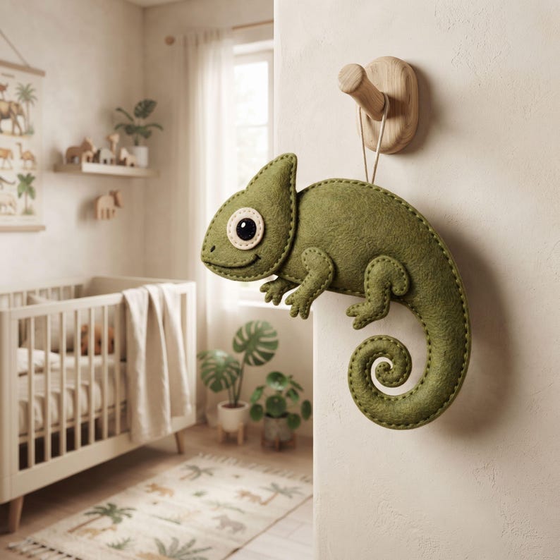 Hand sewn felt chameleon ornament showing four legs and detailed face