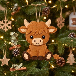 Hand sewn Highland Cow felt ornament showing detailed face, feet, arms and tufted tail