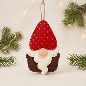 Strawberry gnome sewing pattern pieces including the strawberry hat, cream trim, brown body, nose, and cream beard.